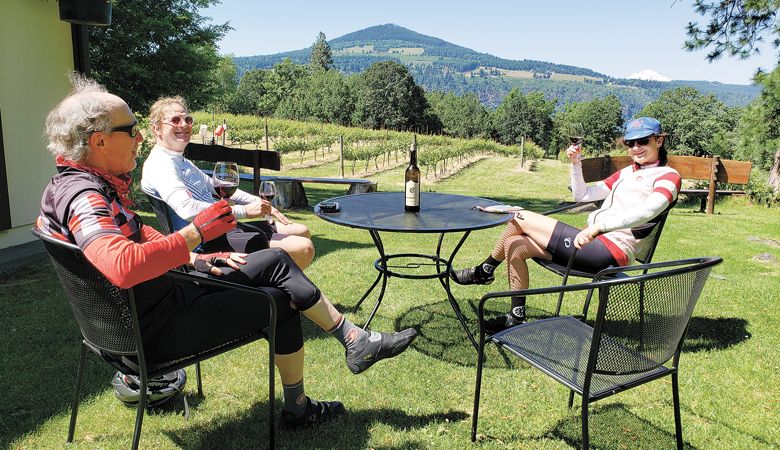 Cyclists enjoy a well-earned glass of Syrah at Cathedral Ridge Winery after a June ride. ##Photo by Dan Shryock