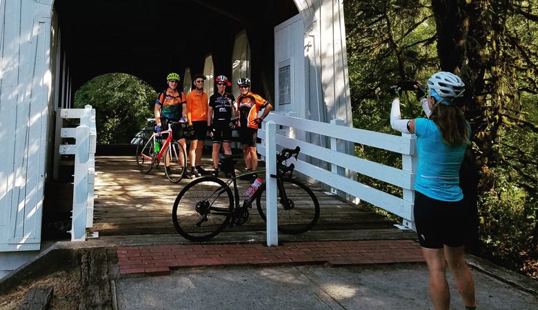Riders
participating in
the Bike Oregon
Wine Country
event stop for a
photo at Ritner
Creek Bridge in
the Kings Valley
area near the
Polk-Benton
county line. ##Photo by Dan Shryock