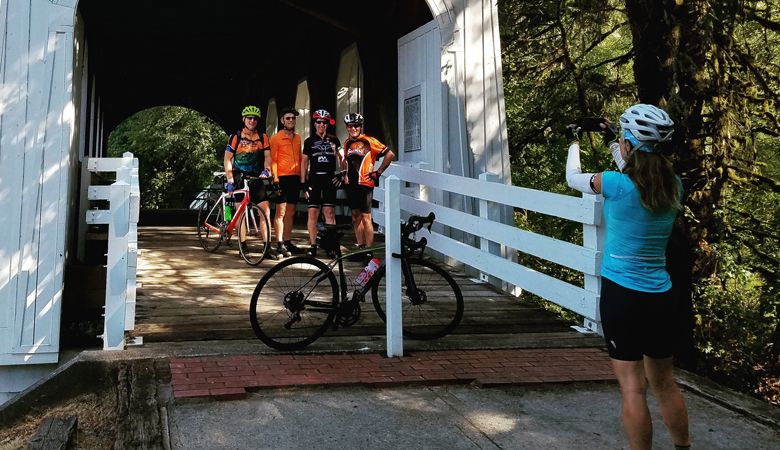 Riders
participating in
the Bike Oregon
Wine Country
event stop for a
photo at Ritner
Creek Bridge in
the Kings Valley
area near the
Polk-Benton
county line. ##Photo by Dan Shryock