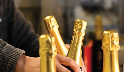 Bottles filled with Méthode Traditionnelle/Méthode Champenoise sparkling wine are packed in case boxes, ready to ship. This is often the final of a dozen touches.