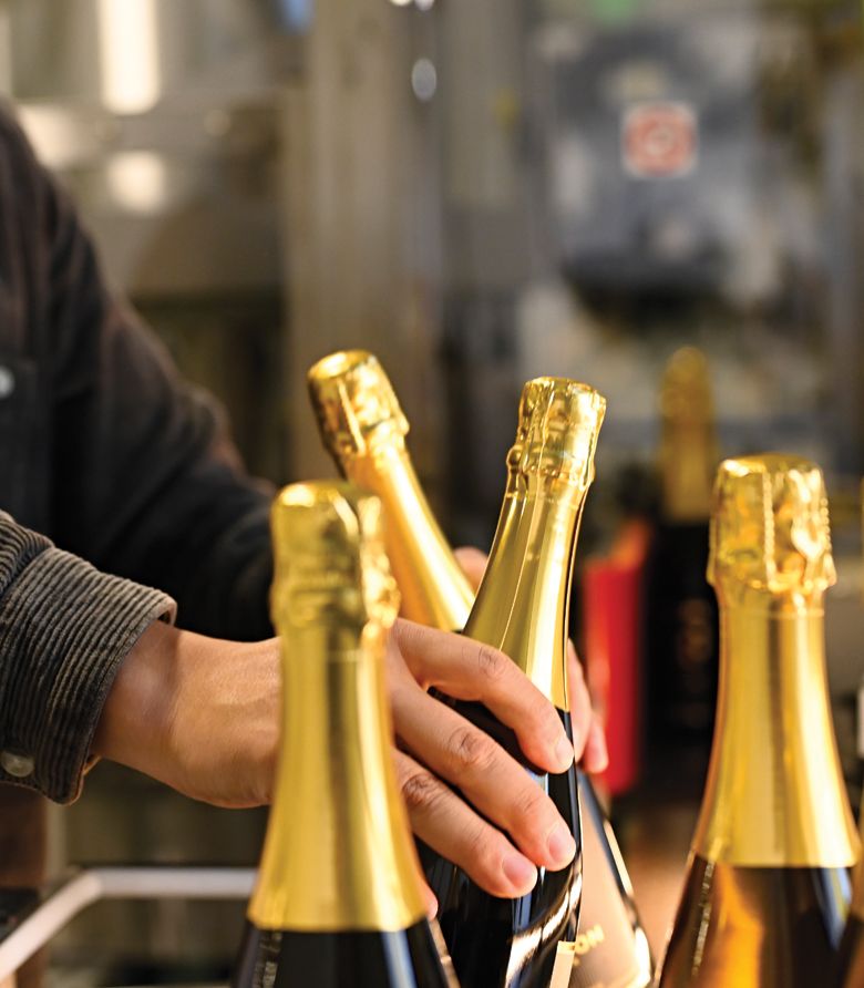 Bottles filled with Méthode Traditionnelle/Méthode Champenoise sparkling wine are packed in case boxes, ready to ship. This is often the final of a dozen touches.