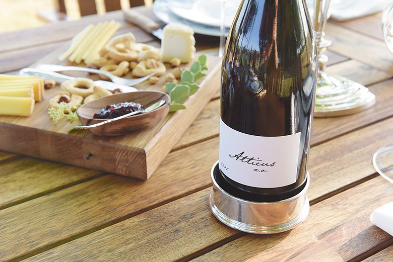 A cheese board and bottle of Atticus Wine on a table. ## Photo by IFM Photography
