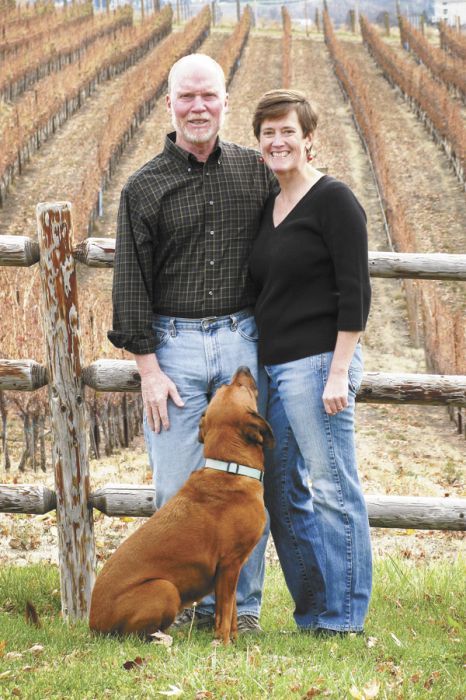Patrick Flannery and Paula Brown stand in front of estate vines with their 7-year-old vineyard pooch, Vino. Patrick Flannery and Paula Brown stand in front of estate vines with their 7-year-old vineyard pooch, Vino.
