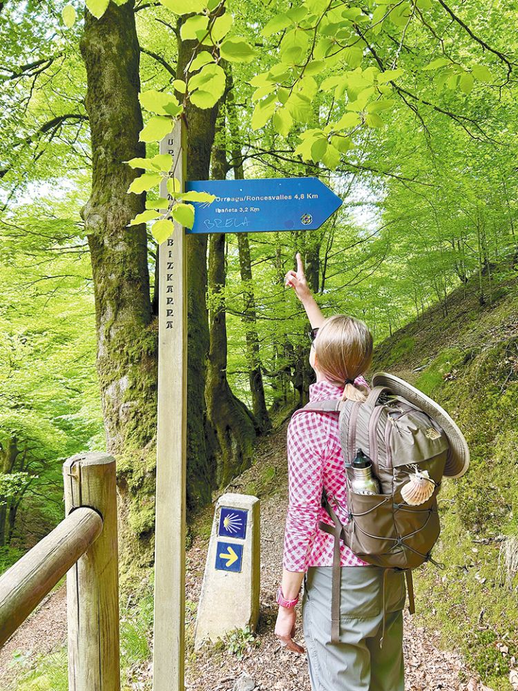 Debbie Schultz pointing to a Camino sign. ## Photo provided by Schultz Glory Oaks Vineyard