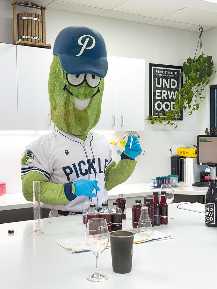 Portland Pickles baseball team&rsquo;s mascot, Dillon T. Pickle, in the lab at Union Wine Co./Underwood Winery. ## Photo provided by Union Wine Co.