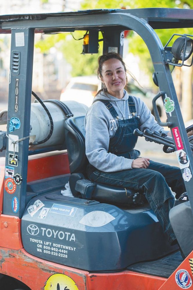 Kate Norris operating a forklift. ## Photo provided by Division Winemaking Company