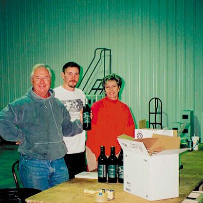Mike Dunham, bottling an early vintage of Dunham Cellars with son, Eric, aided by Joanne, Mike s wife. ## Photo provided by Dunham Cellars Mike Dunham, bottling an early vintage of Dunham Cellars with son, Eric, aided by Joanne, Mike s wife. ## Photo provided by Dunham Cellars