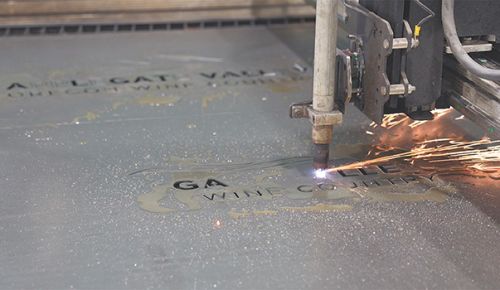 A metal sign being cut with equipment programmed and operated by Eagle Point High School students. ## Photo by Trish Glose