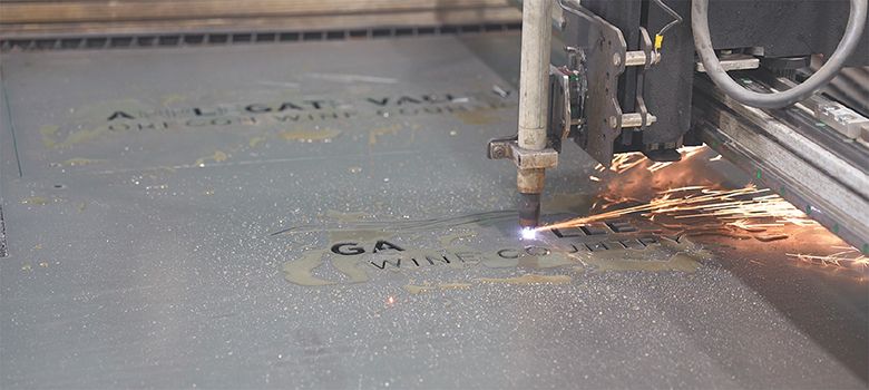 A metal sign being cut with equipment programmed and operated by Eagle Point High School students. ## Photo by Trish Glose