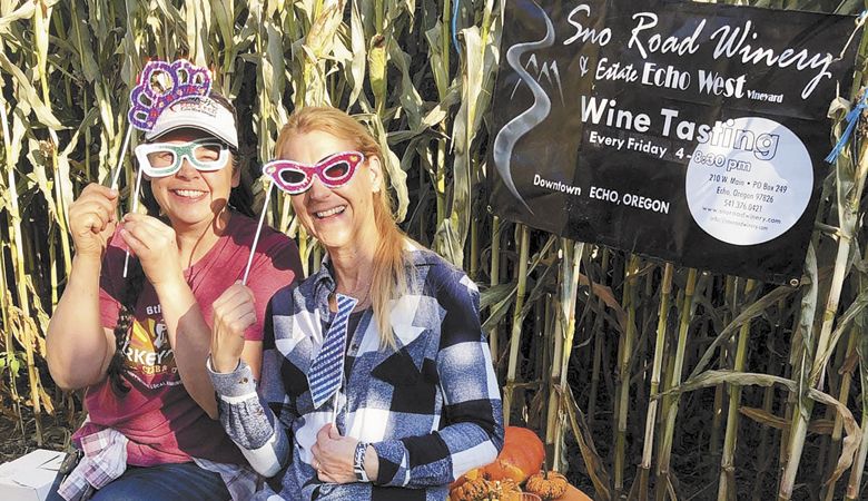Friends prepare for the “Find the Wine & Beer” event inside Echo’s corn maze.##Photo provided