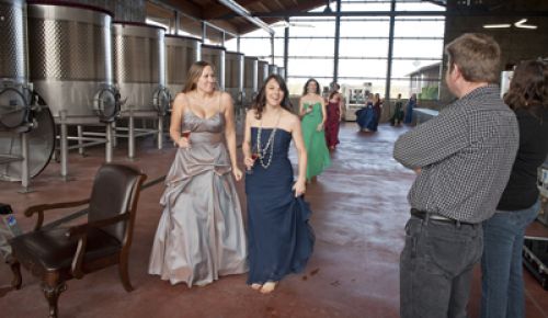 Erica Landon(left) and Jennifer Cossey, followed by Carrie Stigge and the rest of the sommeliers, feel the chill of the fermentation room at Soléna & Grand Cru Estates. Winemaker Bruno Corneaux and OWP editor Hilary Berg watch as they enter.  Photo by Andrea Johnson