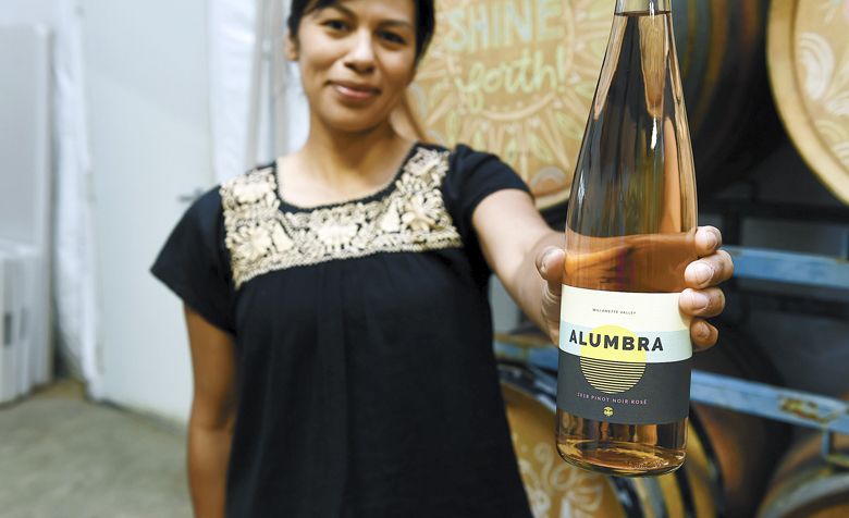 Elena Rodriguez holds a bottle of her recently released Alumbra Cellars 2018 Pinot Noir rosé. ##Photo by Rusty Rae