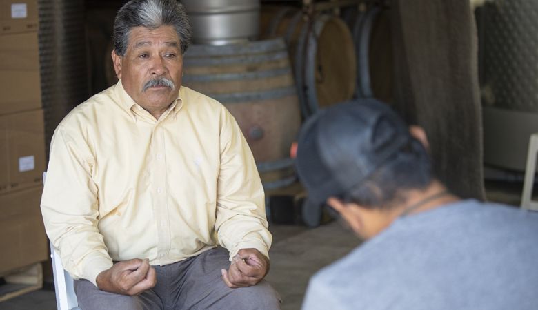 Aquiles Onecimo Giron Sanchez chats with Miguel Lopez. ##Photo by Andrea Johnson