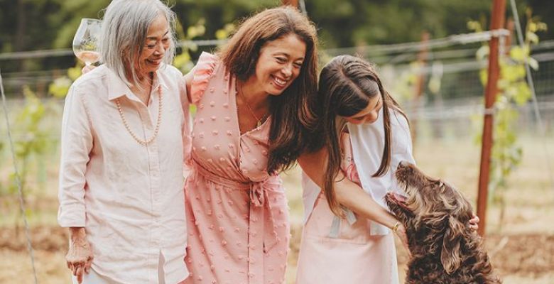 Et Fille Wines  Jessica Mozeico (in pink), standing between her mother, Mona, and daughter, Gabriella, with family dog, Coco Chanel. ## Photo by Foundry 503
