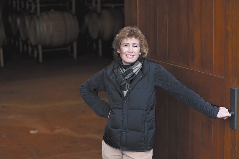 Eugenia Keegan holding open a cellar door. ## Photo by Carolyn Wells-Kramer Eugenia Keegan holding open a cellar door. ## Photo by Carolyn Wells-Kramer