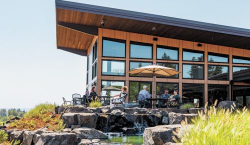 Guests enjoying sunshine and views at the new Domaine Willamette Winery. ##Photo provided