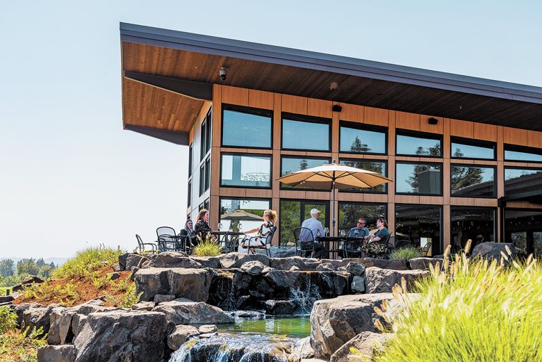 Guests enjoying sunshine and views at the new Domaine Willamette Winery. ##Photo provided