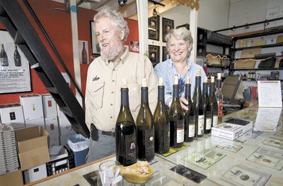 Myron Redford and Viki Wetle, co-owners of Amity Vineyards, beam from behind the tasting bar at the winery. Photo by Marcus Larson,News-Register