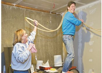 Kathy and Lee Miller organize their hoses at their home
winery. Photo by Janis Miglavs.