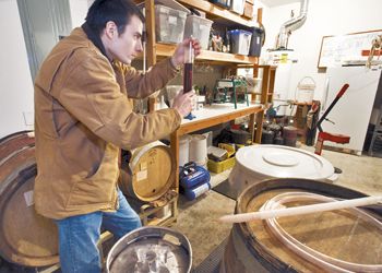 Travis Cook records
his wine’s temperature during fermentation. Photo by Janis Miglavs.