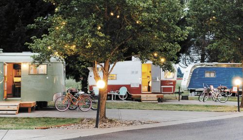 Lights glow above the trailers at The Vintages; each comes with a couple bikes for cruising the Dayton RV park. ##Photo by Kathryn Elsesser