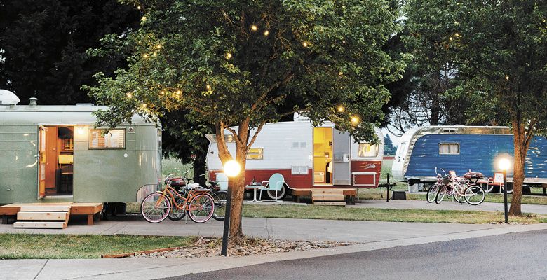 Lights glow above the trailers at The Vintages; each comes with a couple bikes for cruising the Dayton RV park. ##Photo by Kathryn Elsesser