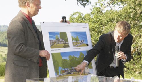 Architects Eric Wilcox
(left) and Troy Ainsworth, from Fletcher Farr Ayotte in Portland, show details of the Lang Center at
the SOWI dedication ceremony on May 20. Photo by Gary Leif.