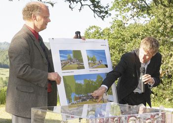 Architects Eric Wilcox
(left) and Troy Ainsworth, from Fletcher Farr Ayotte in Portland, show details of the Lang Center at
the SOWI dedication ceremony on May 20. Photo by Gary Leif.