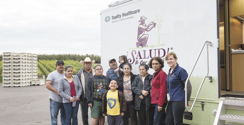 Leda Garside and Community Outreach Nurse Carrie Body with Wellness Clinic patients. ##Photo by Andrea Johnson