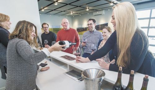 Ellen Brittan and Cat Kaczynski pour customers a taste of Brittan Vineyards’ McMinnville AVA Pinot Noir. ##Photo by Marcus Larson