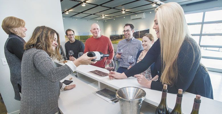 Ellen Brittan and Cat Kaczynski pour customers a taste of Brittan Vineyards’ McMinnville AVA Pinot Noir. ##Photo by Marcus Larson