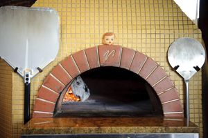 Dolly, the Patron Saint of Pizza guards the wood-fire oven at the Firehouse in Northeast Portland. Dolly, the Patron Saint of Pizza guards the wood-fire oven at the Firehouse in Northeast Portland.