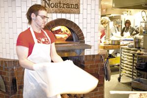 Joshua Shaham throws pizza dough at Nostrana in SE Portland. After opening in 2005, they quickly earned the Oregonian s coveted  Best Restaurant of the Year.    photo by Andrea Johnson.