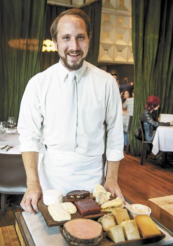 Jesse Seratt, Bluehour s in-house fromager, shows dinner guests the options for a memorable cheese plate.  Photo by Andrea Johnson