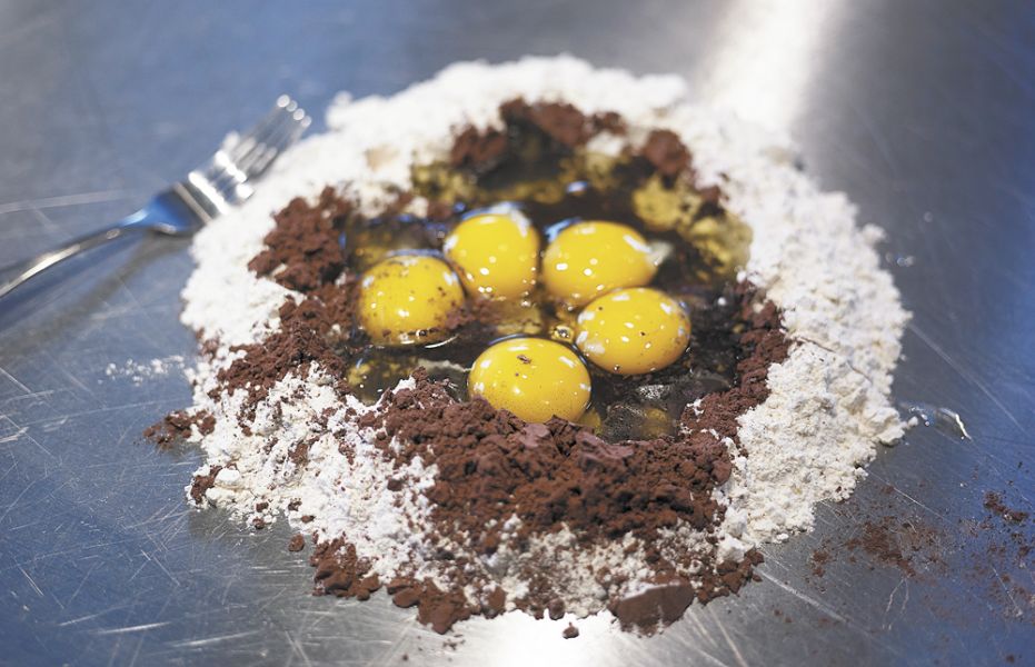 Chef Wendy Bennett starts the pasta-making process by creating a well of flour and adding the eggs. ##Photo by Del Munroe.