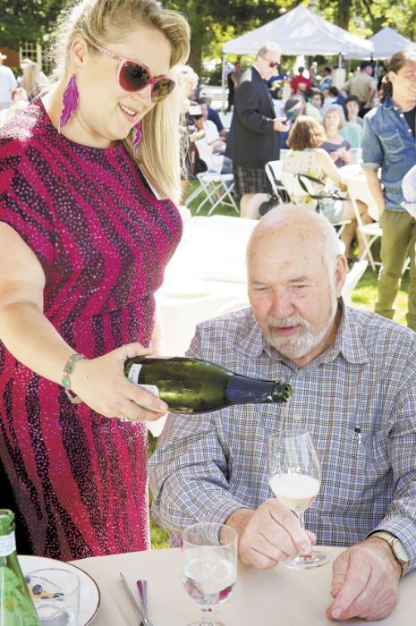 Head sommelier Savanna Ray, dressed up in retro ’80s for IPNC’s 25th anniversary, pours Champagne for Dick Erath at the 2011 event. Photo by Andrea Johnson. Head sommelier Savanna Ray, dressed up in retro ’80s for IPNC’s 25th anniversary, pours Champagne for Dick Erath at the 2011 event. Photo by Andrea Johnson.