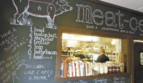 A blackboard explains Smithfields’ menu through a pig diagram, lists local producers and posts pro-meat mantras.
