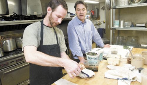 Stecchino Bistro owner Christian Geffrard and chef Mark Cuneo prepare for the dinner crowd. Photo by Marcus Larson.