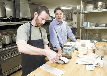 Stecchino Bistro owner Christian Geffrard and chef Mark Cuneo prepare for the dinner crowd. Photo by Marcus Larson.