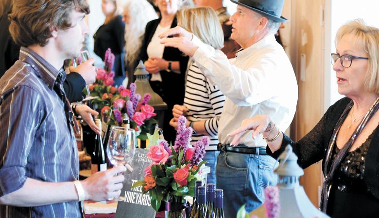 Winemakers and representatives
pour their wares during the 50th Greatest
of the Grape hosted at Southern Oregon
Wine Institute. ##Photo by Andrew Calvert