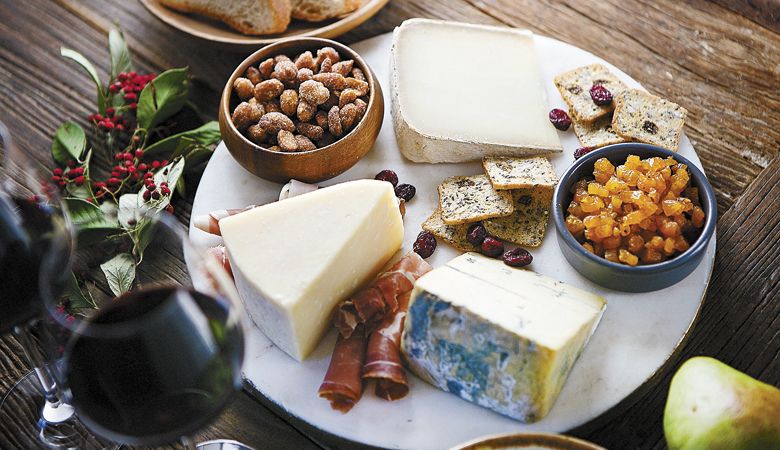 Alongside seed crackers, cured meats, almonds and dried fruit, a trio of cheeses are on display: Face 2 Face (left); Secret de Compostelle (top); Chiriboga Blue (bottom right). ##Photo by Christine Hyatt