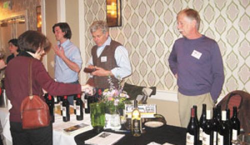 Luke Bradford of Cor Cellars (far left) chats with a taster during the Columbia Gorge AVA event at the Hotel Monaco in Portland as Cor s Ed Cornell (center) and Rob Bell of Cathedral Ridge (far right) look on.