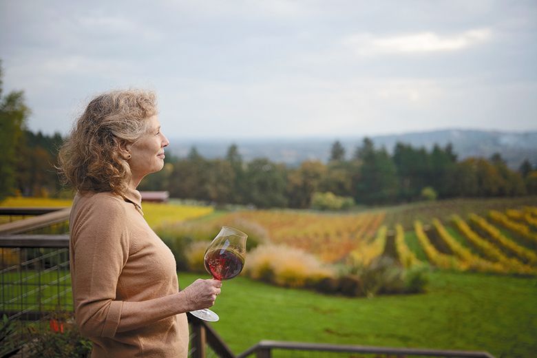 Eugenia Keegan holding a glass of Pinot Noir while looking out over a vineyard. ## Photo by Carolyn Wells-Kramer Eugenia Keegan holding a glass of Pinot Noir while looking out over a vineyard. ## Photo by Carolyn Wells-Kramer
