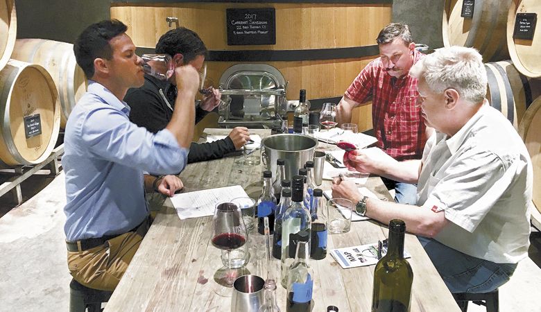 At the blending trial table at Va Piano Vineyards sits (from left) Hanatoro co-owner Kevin Bozada; winemaker Justin Wylie; Jeremy Eubanks, assistant winemaker at Va Piano; and Hanatoro co-owner Steve Thomson. ##Photo provided