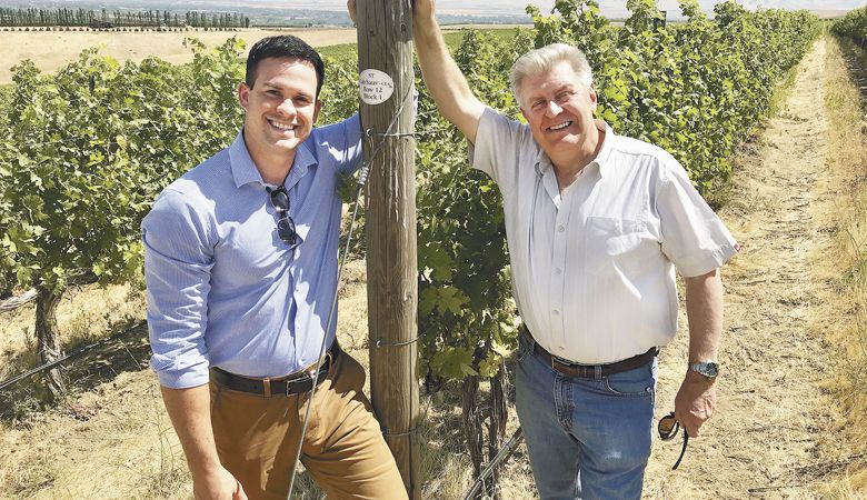 Hanatoro Winery owners Kevin Bozada and Steve Thomson check their Cabernet Sauvignon vines at Octave Vineyard in the Walla Walla Valley.  ##Photo provided