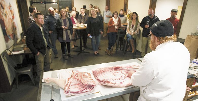 Chef Red Hauge demonstrates butchering a pig prior to a dinner centered on seasonal ingredients. ##Photo by Rockne Roll