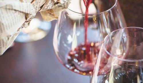 Wine is poured for a premium Pinot Noir blind tasting featuring wines priced at $100 or more.