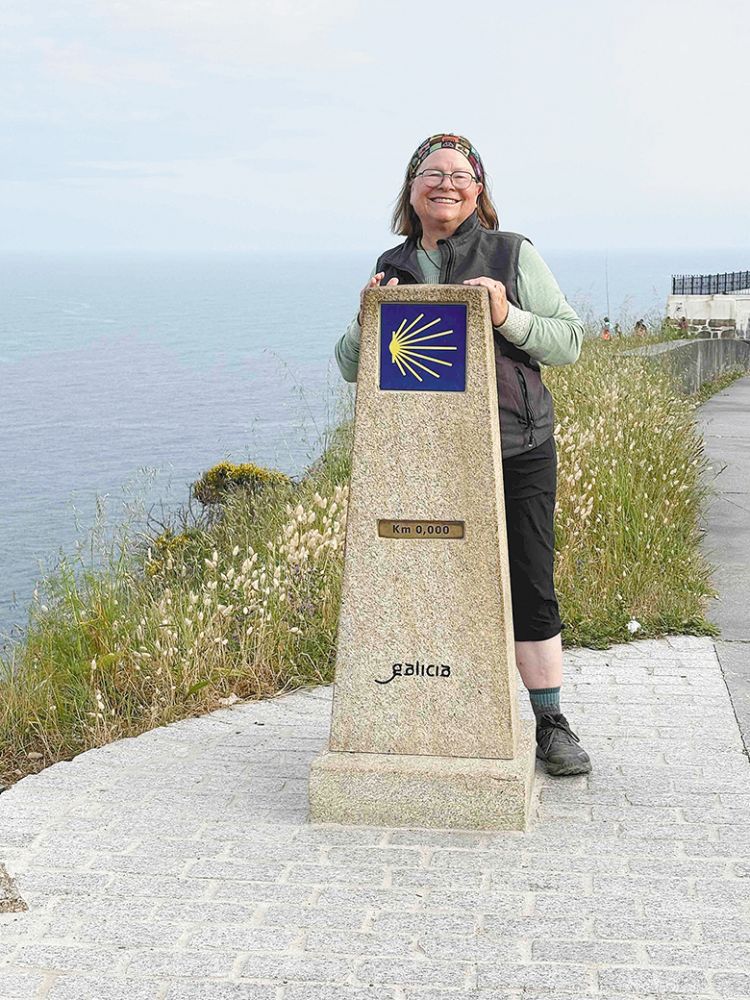 Kathy O&rsquo;Leary posing at the Camino Finisterre Kilometre Zero marker. ## Photo provided by Long Walk Vineyard