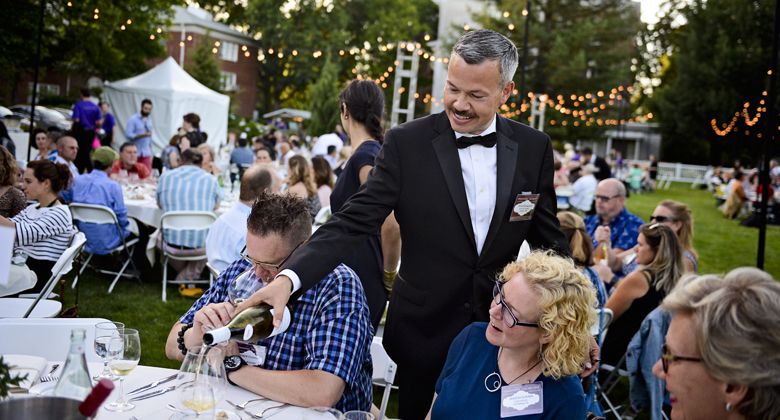 Tom Champine pours a glass of wine for a table of IPNC guests. ##Photo by Carolyn Wells-Kramer