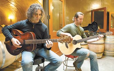 Jay Somers, winemaker/co-owner of J. Christopher Wines plays a tune with assistant winemaker Tim Malone at the entrance of one of the winery’s barrel caves.